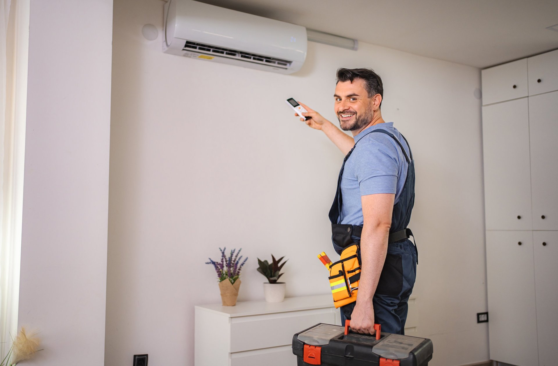Technician installing an air conditioner